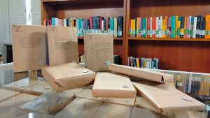 libri su un tavolo della biblioteca incartati con scritta sopra